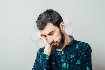Businessman sleeping over gray background