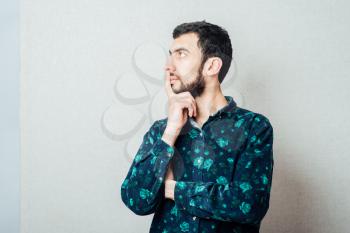 Caucasian Happy Young Man with Beard Thinking Doubting and Considering a Decision