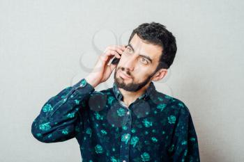 casual young man talking on the phone and smiling 