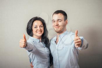 couple showing thumbs up.