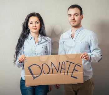 Portrait of a happy young couple with donation