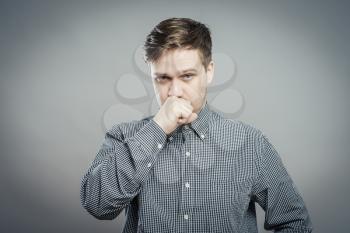 young man thinking with hand on face