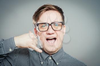 Excited young man in glasses talk by mobile