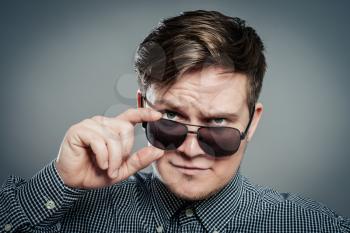 Studio photo of young attractive man in glasses