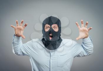 Face of a angry burglar wearing a black ski mask or balaclava 