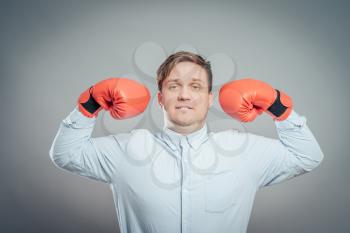 Portrait of young man in red boxing gloves fighting