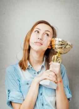 woman with the cup winner. isolated on gray background