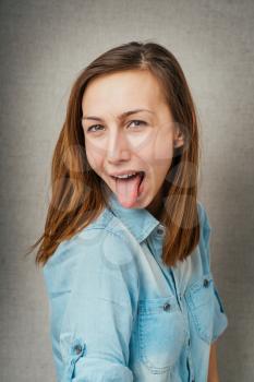 portrait of a young girl showing her tongue