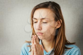 girl praying with his eyes closed