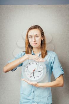 girl holding a clock