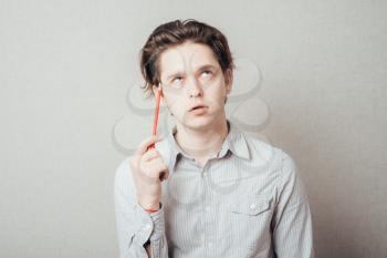 man is thinking about something with pencil