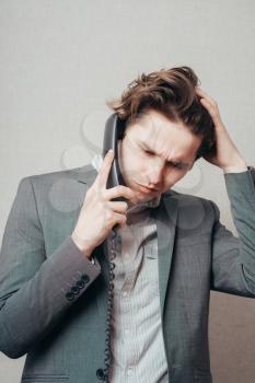 Portrait of a businessman on phone in his office
