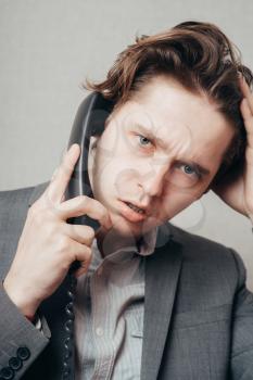 Portrait of a businessman on phone in his office
