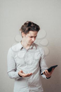 Young businessman using a tablet computer - isolated over a gray background