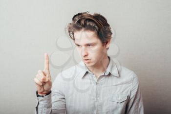 Young man in a shirt . Raised hand is pointing to the top. gesture. photo shoot.