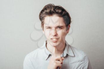 man thinking and holding a finger under his chin