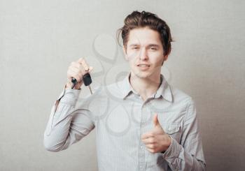 young man holding a key
