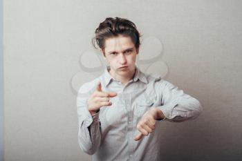 young man pointing to the clock on the invisible hand