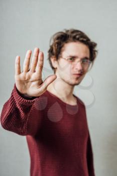 young man saying stop denial gesture