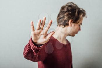 young man saying stop denial gesture