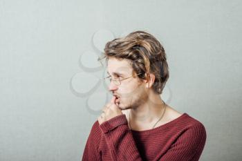 young business man biting his nails . on a light gray studio background