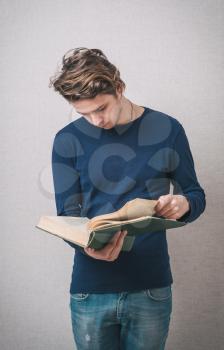 handsome young man reading a book