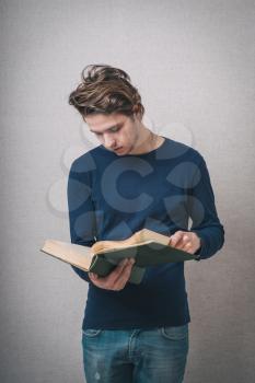 handsome young man reading a book