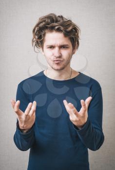 young man holding in his hands something invisible
