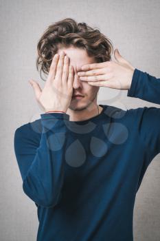 young man eyes with his hands