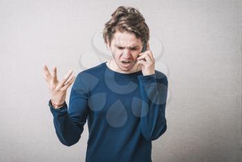 Angry business man screaming on cell mobile phone, conversation