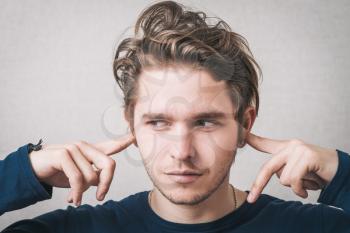 man closed his ears with his hands