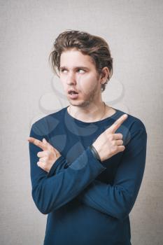 Man showing thumbs up in different directions. On a gray background.