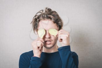 The man closed his eyes with paper stickers. Gray background