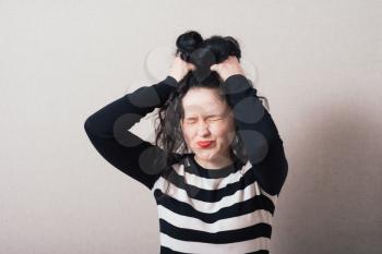 woman tearing her hair and shouting