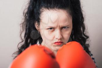 businesswoman with boxing gloves ready for fighting