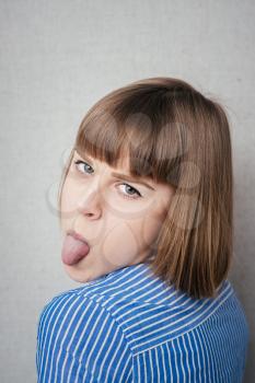 Girl sticking her tongue out, isolated