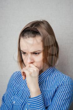 portrait of a worried young woman with a pensive gesture