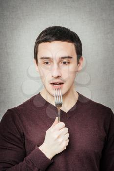 young man with a fork
