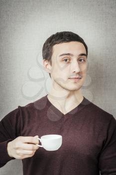 young man offers a cup of espresso