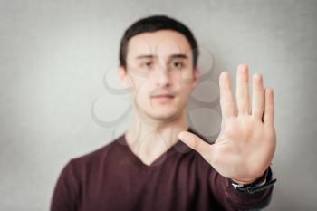 Young  man requiring stop with his hand.