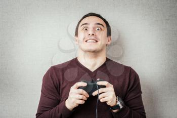 Excited young man playing video games. 