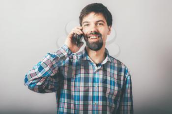 bearded man talking on the phone