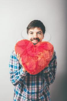 a man holding a big heart