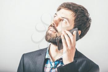 bearded businessman talking on the phone
