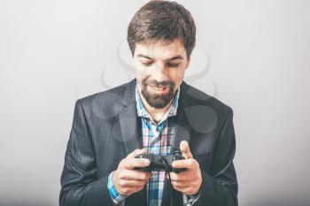 bearded businessman playing on the joystick console