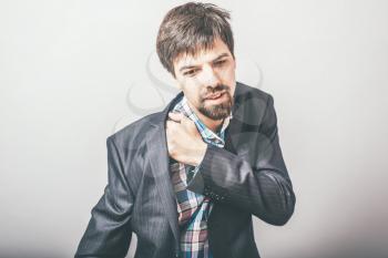businessman has a pain in his shoulder