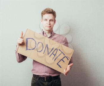 man shows a poster donate