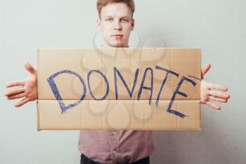 man shows a poster donate