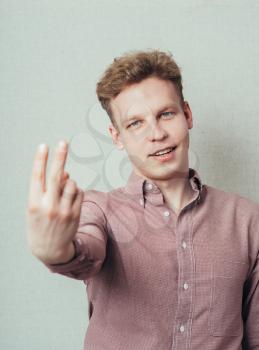 man showing two fingers