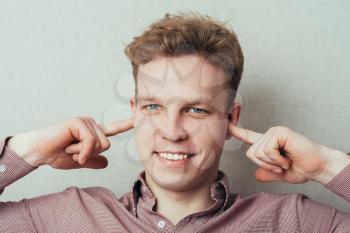 man covers his ears with his hands